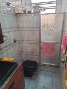 a bathroom with a black toilet and a sink at I Love Rio Hostel in Rio de Janeiro
