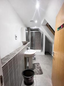 a white bathroom with a sink and a window at Private Rooms at Oxley Comfy House - Milton Keynes in Broughton