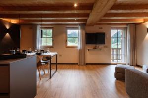 a living room with a table and a couch at Sun Villa Genf Spa - Relax in Livigno
