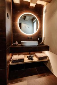 a bathroom with a sink and a mirror at Sun Villa Genf Spa - Relax in Livigno