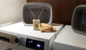 a bottle of oil sitting on top of a washing machine at Sun Villa Genf Spa - Relax in Livigno