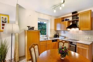 a kitchen with a wooden table and a dining room at Ferienwohnung Rotdorn in Schmallenberg