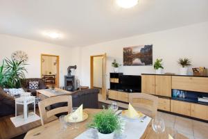 a living room with a couch and a table at Kirsten's Hike n Bike Ferienwohnung in Schmallenberg