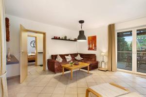 a living room with a couch and a table at Ferienwohnung Rotdorn in Schmallenberg