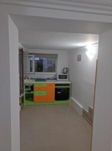 a kitchen with orange and green cabinets in a room at Old Town Plovdiv House Стаи за гости Марчеви - Стария град Пловдив in Plovdiv