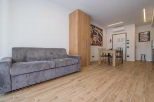 a living room with a couch and a table at BergamoCityCenter 03 in Bergamo