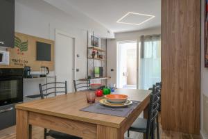 a kitchen and dining room with a wooden table at BergamoCityCenter 03 in Bergamo