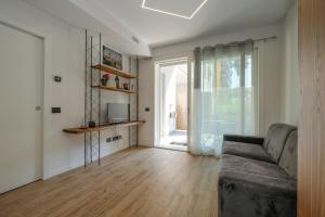 a living room with a couch and a large window at BergamoCityCenter 03 in Bergamo
