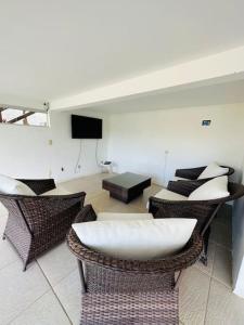 a living room with a couch and chairs and a table at Villa Simone in Natal