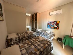 a hotel room with two beds in a room at Villa Simone in Natal