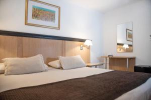 Cama ou camas em um quarto em Argentino Hotel