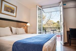 Cama ou camas em um quarto em Argentino Hotel