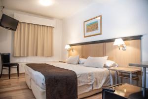 Cama ou camas em um quarto em Argentino Hotel