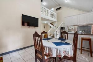 a kitchen with a table and chairs in a room at Shaw Park Gem Apt 12D in Ocho Rios