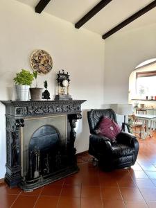 a living room with a chair and a fireplace at Apartment in Villa La Carruba in Rivergaro