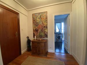 a hallway of a home with a door and a painting at Los Angeles House in Sopelana