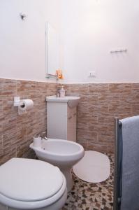 een badkamer met een wit toilet en een wastafel bij Casa vacanze Cristina in Noto
