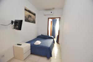 Postel nebo postele na pokoji v ubytování Hotel Tres Leones