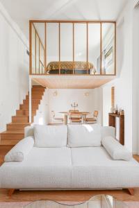 a living room with a white couch and a table at Suite luxueuse avec jardin privé Sauna et Jacuzzi in Paris