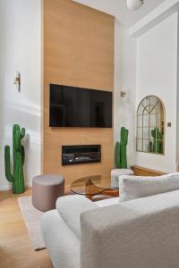 a living room with a couch and a tv at Suite luxueuse avec jardin privé Sauna et Jacuzzi in Paris