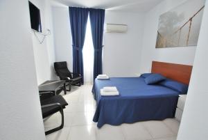 Postel nebo postele na pokoji v ubytování Hotel Tres Leones