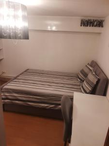 a bedroom with a bed and a table with a chair at Maison d'ozoir in Ozoir-la-Ferrière