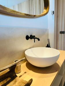 een witte wastafel op een aanrecht in een badkamer bij BONK suites in Middelkerke
