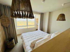 a bedroom with a large bed and a window at BONK suites in Middelkerke