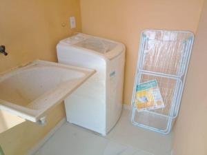 a washing machine and a sink in a room at A janela do amanhecer in Maxaranguape