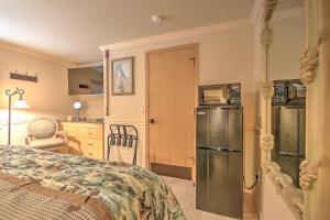 a room with a bed and a refrigerator and a kitchen at Yellowstone Gateway Inn in Gardiner