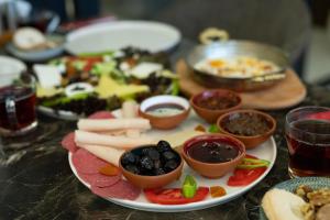a plate with different types of food on a table at Classio Hotel Kadıköy in Istanbul