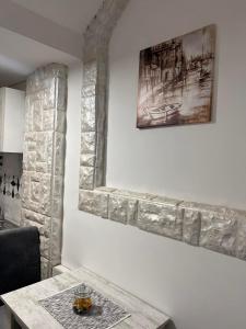 a dining room with a table and a picture on the wall at Apartmani River Priboj in Čitluk