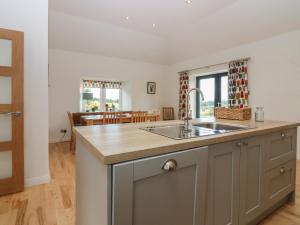 a kitchen with a sink and a counter top at Whitehouse Woodwrae in Forfar