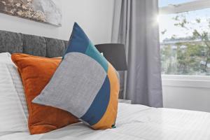 a pillow sitting on top of a bed with a window at Stunning 1 & 2 bedroom Apartments Central London ZONE 1 in London
