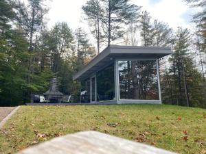 a house with a large window in a yard at Vermont Mirror House in Guilford