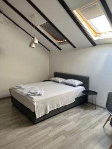 a bedroom with a bed and a table in it at Apartments Ejla&Una in Mostar