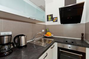 a kitchen with a sink and a counter top at Bepo Studio Apartment - FREE PARKING in Split