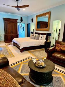 a large bedroom with a bed and a couch at The Presidential at Forty 4 On Hoog Street in Polokwane