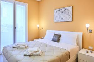 a bedroom with a large bed with towels on it at Mabellini Lifestyle in Fano