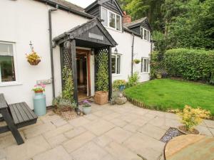 a garden entrance to a white house with a patio at Pen Y Groes in Welshpool