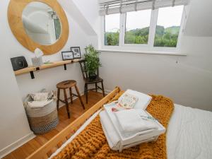 a room with a bed with a mirror and a stool at Pen Y Groes in Welshpool