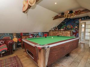 a living room with a pool table in it at Brandeers Long Barn in Malmesbury