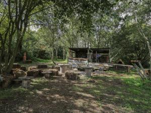a group of tables and chairs in a forest at Brandeers Studio in Malmesbury