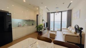 a kitchen and living room with a table and chairs at Vinhomes Skylake Hanoi - CitiHome in Hanoi