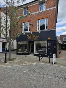 a store front of a brick building at BridgeCity Spectacular Morden 2 bedroom flat in Ashford Town Centre in Kent