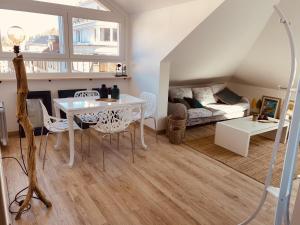uma sala de estar com uma mesa e um sofá em LA MARIEFACTURE - Comme un Poisson dans l'eau em Saint-Avold
