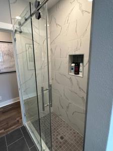 a shower with a glass door in a bathroom at Elegant 1 Bdr Montrose-Bologna@The Italian Plaza in Houston