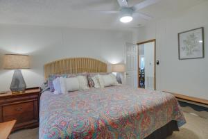 a bedroom with a large bed with a colorful bedspread at Spacious Home 10 Miles to Wintergreen Resort! in Nellysford