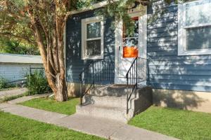a blue house with stairs leading to the front door at 214: Lovely fully furnished 1 bedroom! in Billings