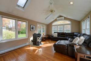 a living room with leather furniture and windows at Spacious Oxford Home with Pool - 4 Mi to Lake! 